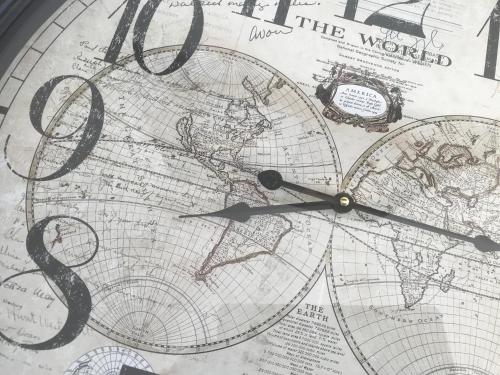 a clock on top of a world map at Domaine Georges V in Saint-Junien