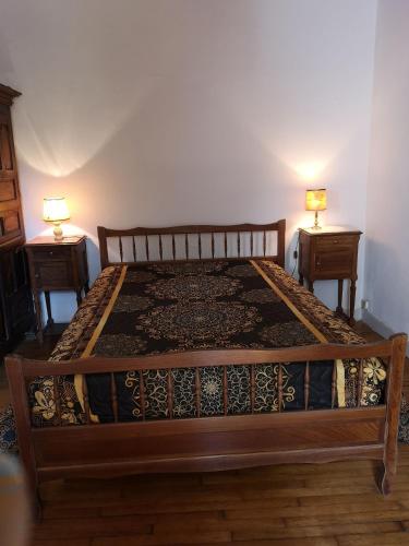 a bed in a room with two night stands at La maison de Zélia in Boissières
