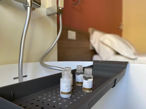 two bottles of essential oils sitting on a table at Levante apartment and room in Bari