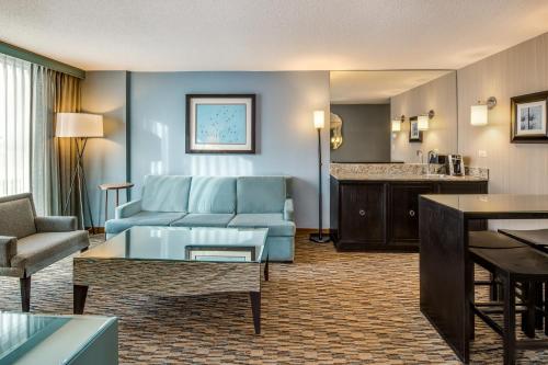 a living room with a couch and a table at Crowne Plaza Chicago O'Hare Hotel & Conference Center by IHG in Rosemont
