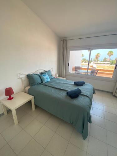 a bedroom with a bed and a window with a view at Island Village Ocean View in Adeje