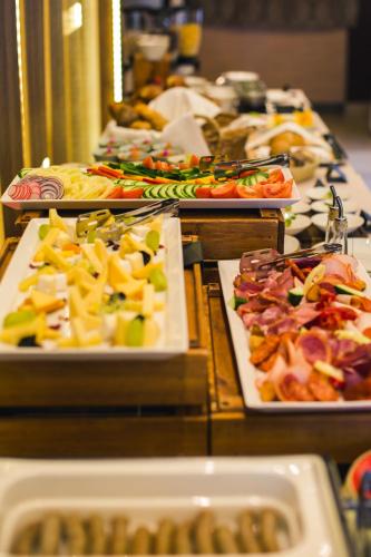 a buffet line with many different types of food at Tópart Hotel in Balatonvilágos