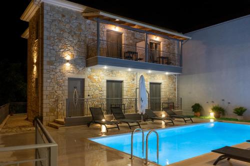 a villa with a swimming pool in front of a building at Sirius luxury Boutique in Sivota
