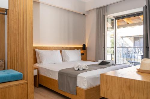 a bedroom with a large bed and a balcony at Sirius luxury Boutique in Syvota