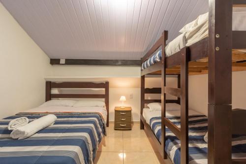 a bedroom with two bunk beds and a lamp at BH Studios Hotel Brás in Sao Paulo