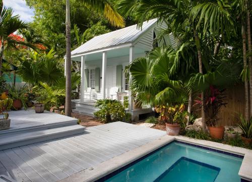 a house with a swimming pool in front of a house at Bahama Gardens - Conch House in Key West
