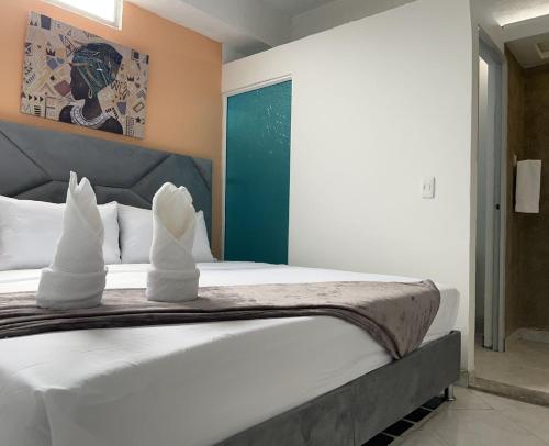 En eller flere senge i et værelse på AW Hotel Vipassa Urban