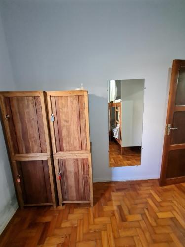 a room with two wooden cabinets and a mirror at HOSTEL BADULACK in Capitólio