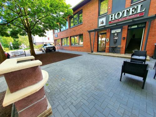 a brick building with a hotel on a street at Pionier Hotel Hamburg Wandsbek in Hamburg