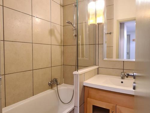 a bathroom with a tub and a sink and a shower at Appartement Flaine, 2 pièces, 6 personnes - FR-1-425-153 in Flaine