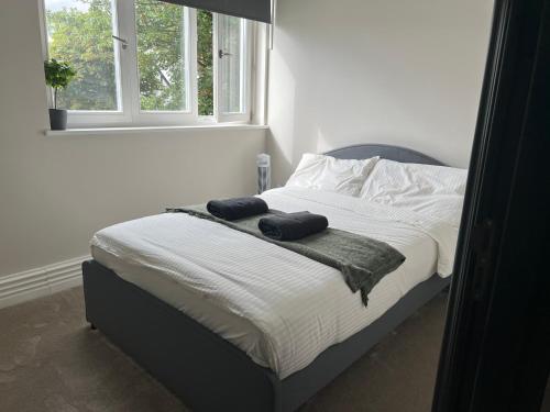 a bedroom with a bed with two towels on it at Bright & Modern 2 bedroom In Hendon in Hendon