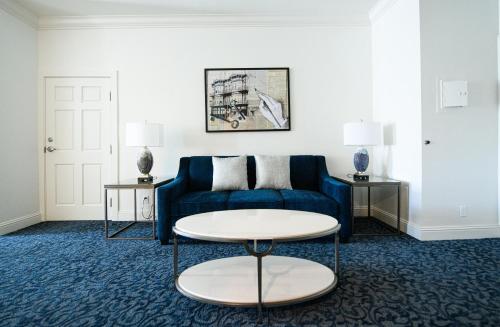 a living room with a blue couch and a table at Horton Grand Hotel in San Diego