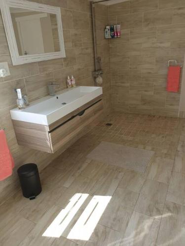 a bathroom with a white tub and a mirror at Beach House with DSTV & WIFI & basic housekeeping in Knysna