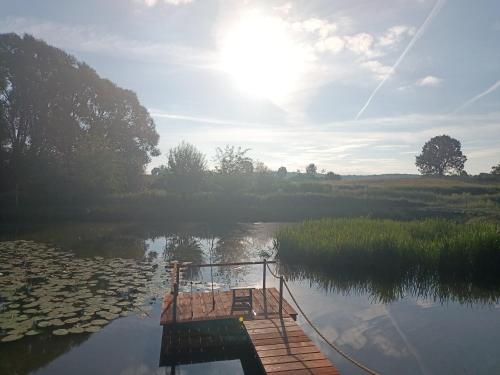 a boat is docked on a body of water at Smocze Ranczo 2 in Ośno Lubuskie