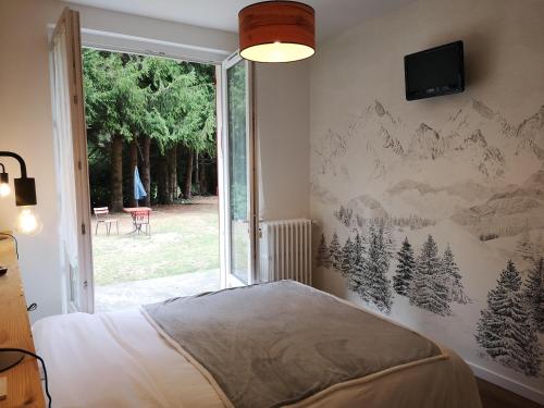 a bedroom with a mural of mountains on the wall at Le Relais d'Avajan in Avajan