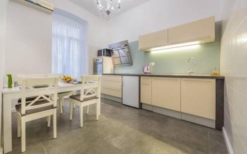 a kitchen with a table and chairs in a room at Apartment Cont in Rijeka