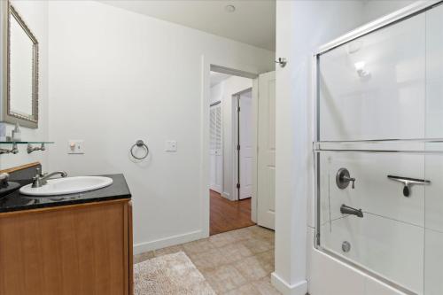 a bathroom with a sink and a shower at The Wood Chalet Hot Tub BBQ Redwoods in Guerneville