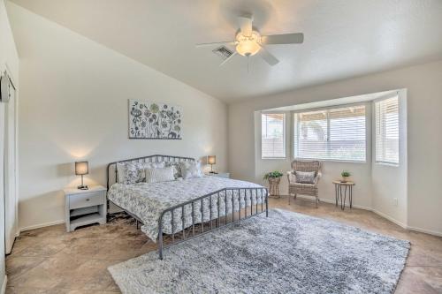 a bedroom with a bed and a ceiling fan at Sunny Yuma Retreat with Private Pool and Grill! in Yuma