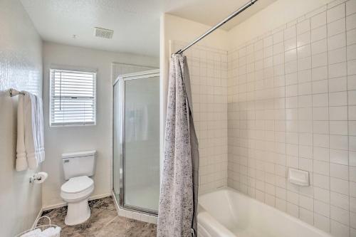 a bathroom with a tub and a toilet and a shower at Sunny Yuma Retreat with Private Pool and Grill! in Yuma