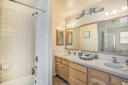 a bathroom with two sinks and a tub and a mirror at Sunny Yuma Retreat with Private Pool and Grill! in Yuma