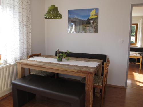 a dining room table and chairs with a table and a lamp at Apartement Gute Laune in Mieming