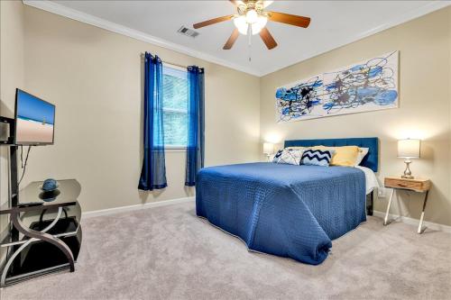 a bedroom with a blue bed and a ceiling fan at Atlanta Private Charming Room 2 in Atlanta