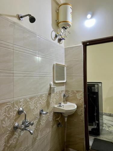 a bathroom with a sink and a mirror at Home to explore Food, History & Shopping in Hyderabad