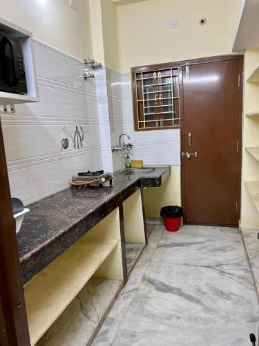 a bathroom with a counter with a skateboard on it at Home to explore Food, History & Shopping in Hyderabad