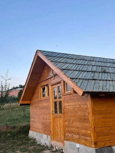 a small wooden cabin with a metal roof at Brvnara Krin 1 in Nova Varoš
