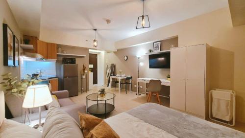 a living room and kitchen with a couch and a table at The Nook at Serin Tagaytay in Tagaytay