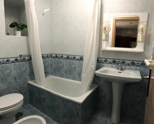 a bathroom with a tub and a sink and a toilet at Casa Pepe La Rosa in Tolox