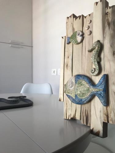 a desk with a computer and a table with a fish on it at SeSil Amare in Porto Recanati