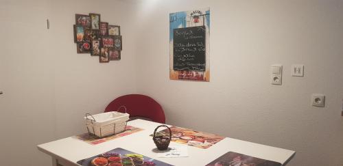 a table in a room with a white table with a chalkboard at Ferienwohnung MAI in Glauchau