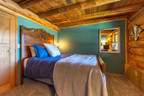 a bedroom with a bed and a mirror in a room at Rowland Log Cabin home in Lyle