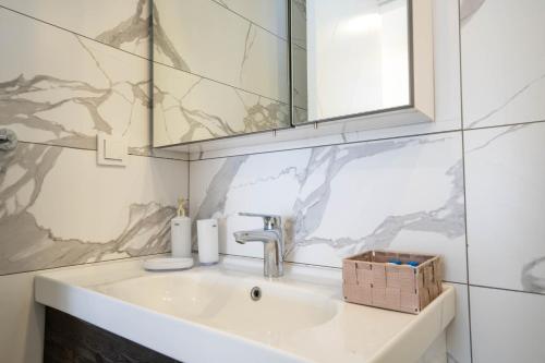 a bathroom with a sink and a mirror at Naz Liman Otel Bodrum in Bodrum City