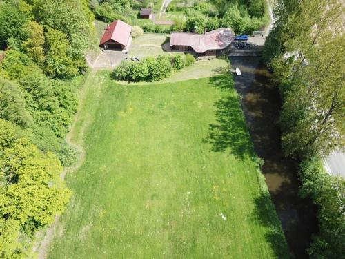 an aerial view of a grassy field next to a river at Chalet am See in Sontra