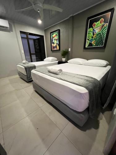 two beds sitting in a room with at La Posada del Mar in Dominical