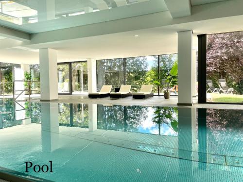 a swimming pool in a house with glass walls at Ferienwohnung am Schluchsee in Schluchsee