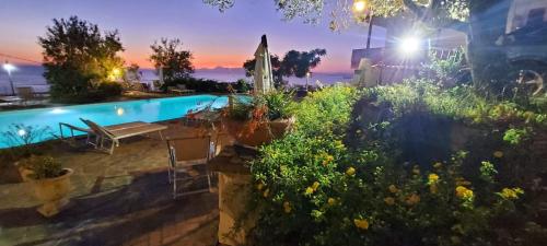 a backyard with a swimming pool at night at Villa Malandrino Guest House in Agropoli