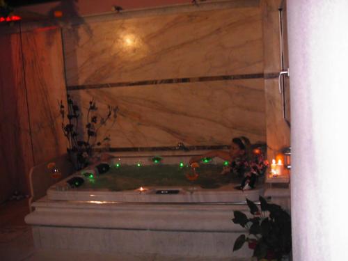 a bath tub with green lights in a room at B&B Al Cristo in SantʼAmbrogio di Valpolicella