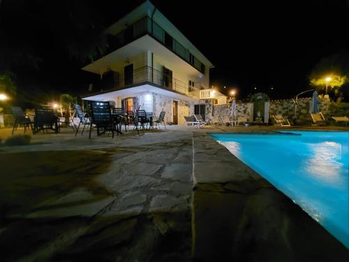 a villa with a swimming pool at night at Villa Malandrino Guest House in Agropoli