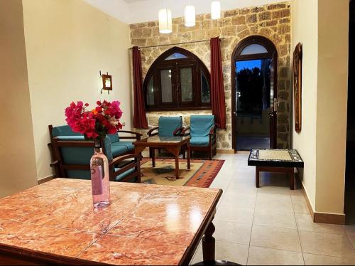 a living room with a vase of flowers on a table at palm shadow resort in Tunis
