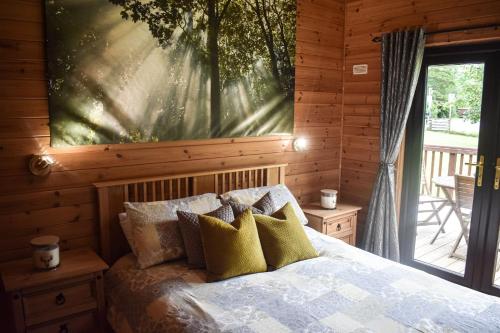 a bedroom with a bed and a large painting on the wall at Lodge at Loch Lomond in Glasgow