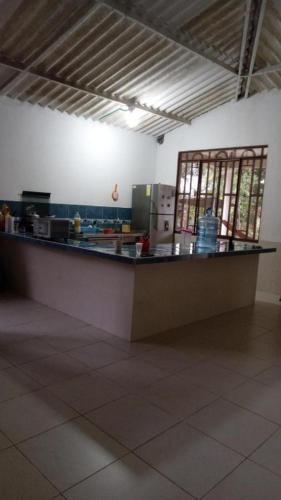 a kitchen with a long counter in a room at Casa de descanso - Finca Los Primos in San Luis de Cubarral