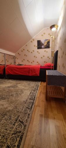 a room with a bed and a rug at Fjord Panorama Homestay in Molde