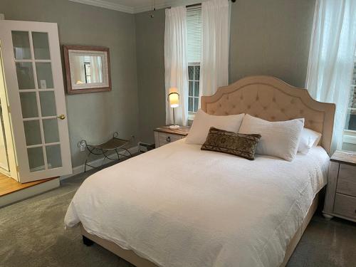 a bedroom with a large white bed with two pillows at The Millhouse Downtown Chester in Chester