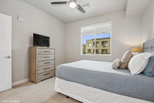 a bedroom with a bed and a flat screen tv at LUX 2 BED DESERT RIDGE 2 HEATED POOLS GYM in Phoenix
