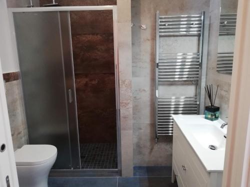 a bathroom with a shower and a toilet and a sink at Domus Mea in Nardò