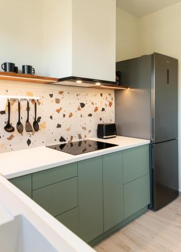a kitchen with blue cabinets and a counter top at Nomas Living in Kalamaki