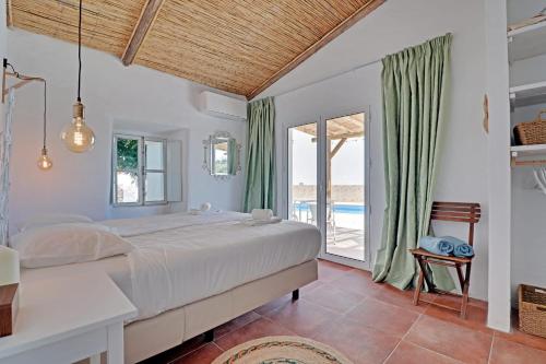 1 dormitorio con 1 cama grande y balcón en Casa Pedra São Romão en São Brás de Alportel